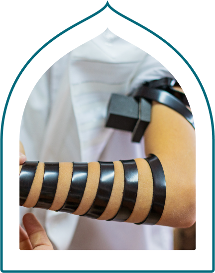 boy putting on tefillin