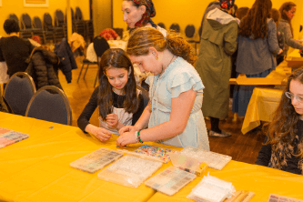 two girls doing an arts and crafts project