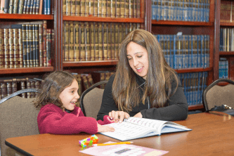 a mother and daughter learning together